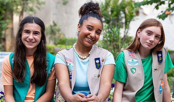 Older girl scouts sitting and smiling