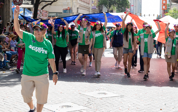 GSSWT CEO Angie Salinas talking to young girl scouts