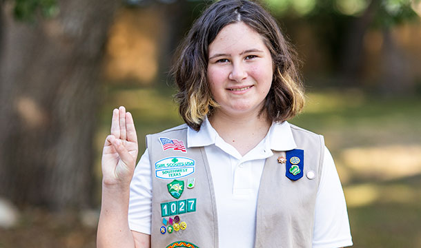 girl scout cadette with girl scout promise sign