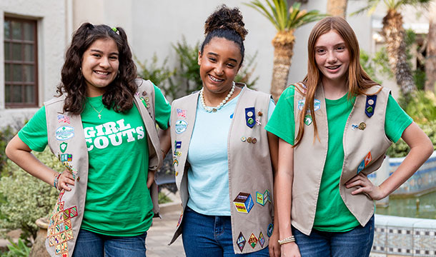 three older girl scouts posing and smiling