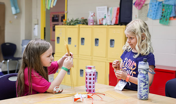 two girls at camp metro doing an activity