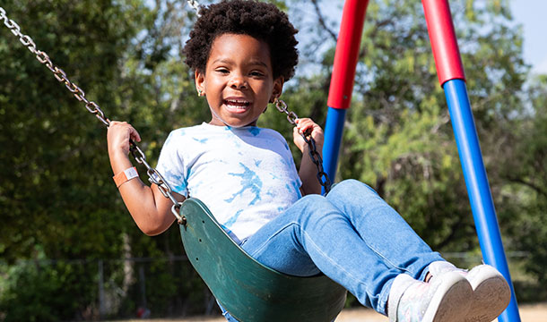 young girl swinging at camp