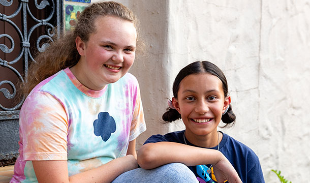 two friends smiling next to each other