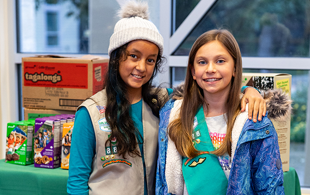 girl scout cadette at her cookie booth 