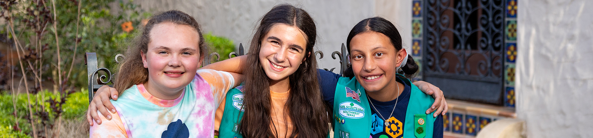  three girl scout friends posing and smiling 