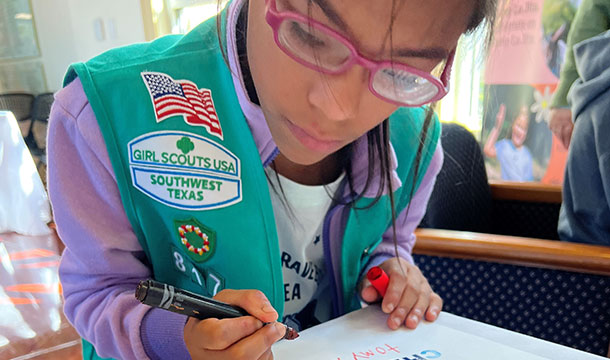 Girl Scout Junior writing with marker