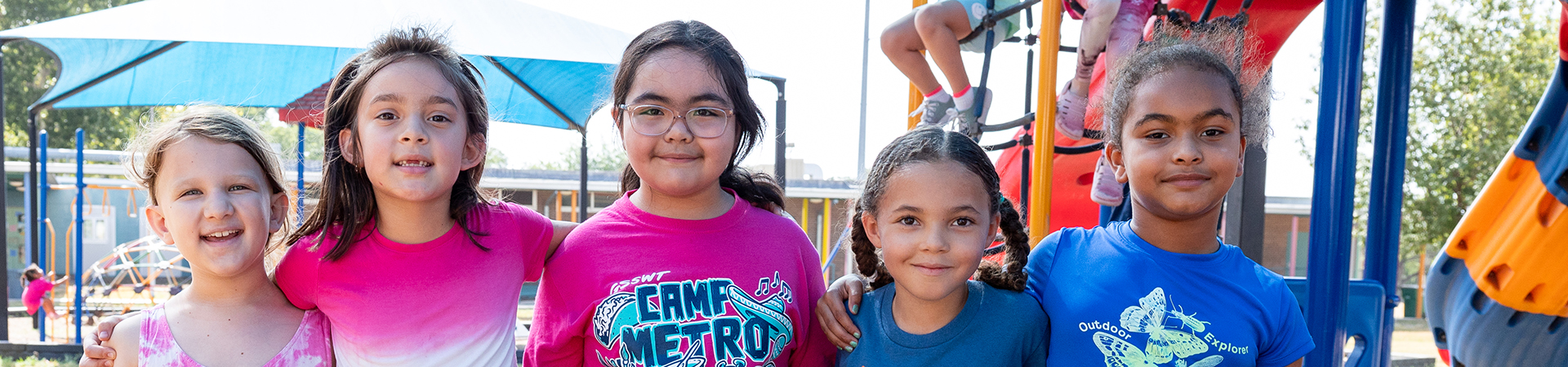  young girl scouts in a line smiling 