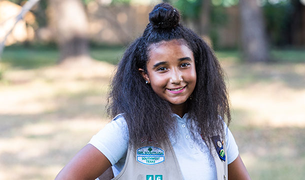 girl scout in khaki uniform smiling