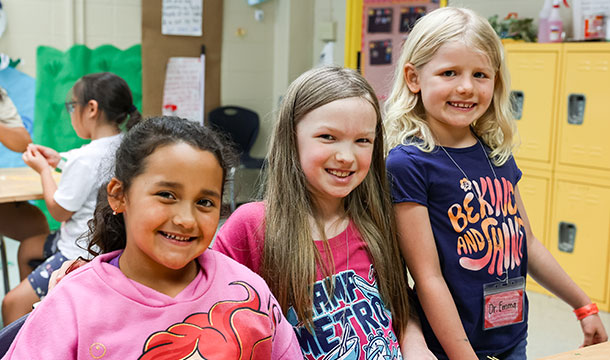 three young girls smiling